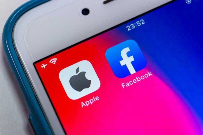 1907935201 Apple and Facebook apps on smartphone screen
