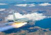 Passenger airplane with rocket engine flying over countryside