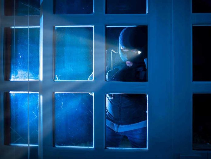 Masked figure peering through glass door at night