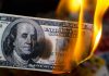 Burning hundred-dollar bill with visible flames