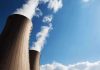 Cooling towers of a nuclear power plant emitting steam against a blue sky