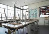 Empty classroom with chairs on top of desks