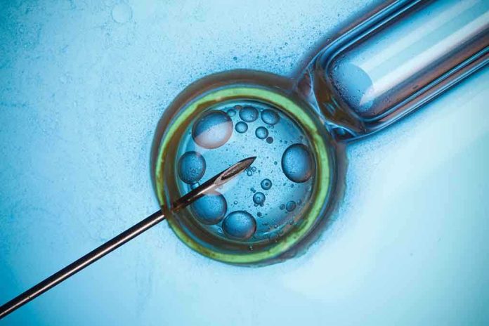 Close up of a needle and vial with liquid droplets on a blue background