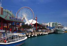 Navy Pier in Chicago with a ferris wheel and boats along the waterfront