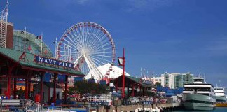 Navy Pier in Chicago with a ferris wheel and boats along the waterfront