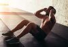 Man performing sit ups in a gym setting