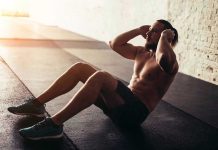 Man performing sit ups in a gym setting