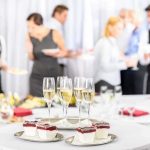 A table set with champagne glasses and desserts at a social event