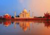The Taj Mahal reflecting in water during sunset