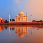 The Taj Mahal reflecting in water during sunset
