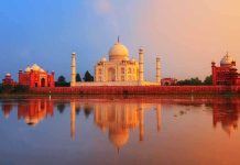 The Taj Mahal reflecting in water during sunset
