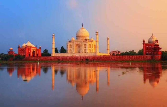 shutterstock_196794914.jpg The Taj Mahal reflecting in water during sunset
