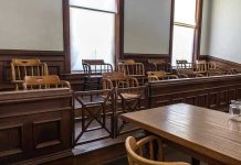 Empty jury box and table in courtroom.