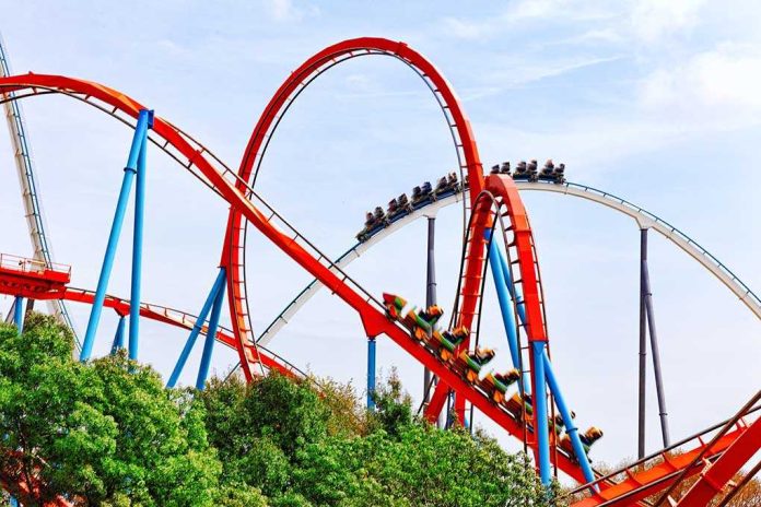 shutterstock_232504156.jpg Colorful roller coaster with riders on a sunny day