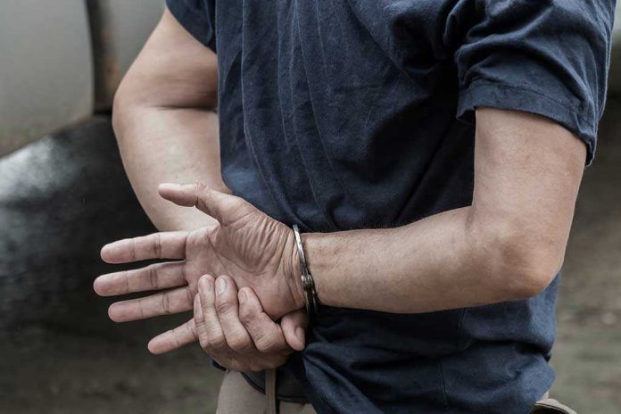 1115333126 Person in handcuffs with hands behind back.