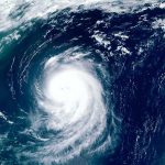 FEMA Announces Extended Aid Program For Hurricane Helene Victims Satellite view of a massive hurricane over the ocean.