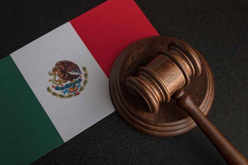 Gavel on Mexican flag background.