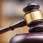 Judge Rejects Motion Against Musk’s Controversial Government Role Gavel striking block in courtroom setting