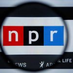 What Keith Woods’s Departure Means For DEI Efforts Magnifying glass over NPR logo on screen