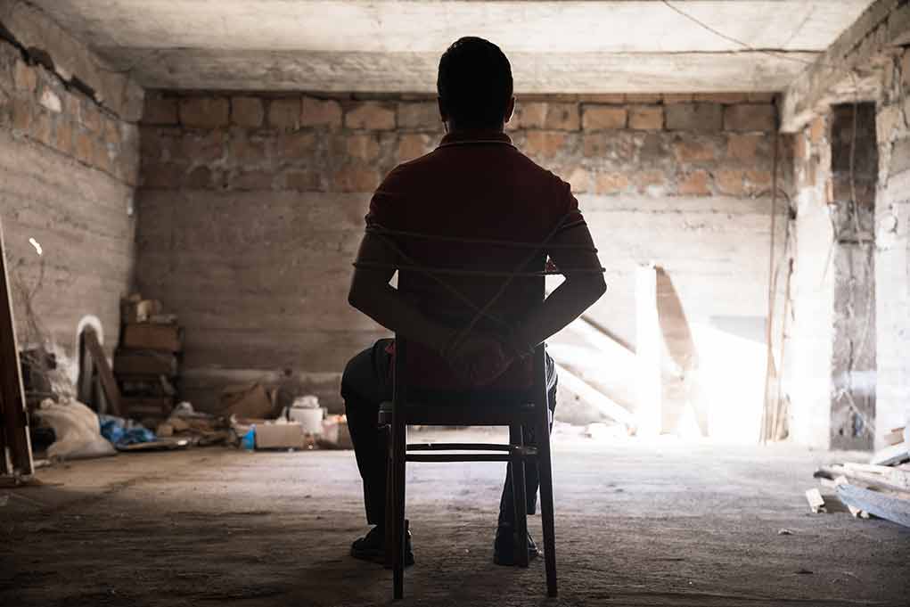 1784023241 featured image Person tied to chair in dimly lit room.