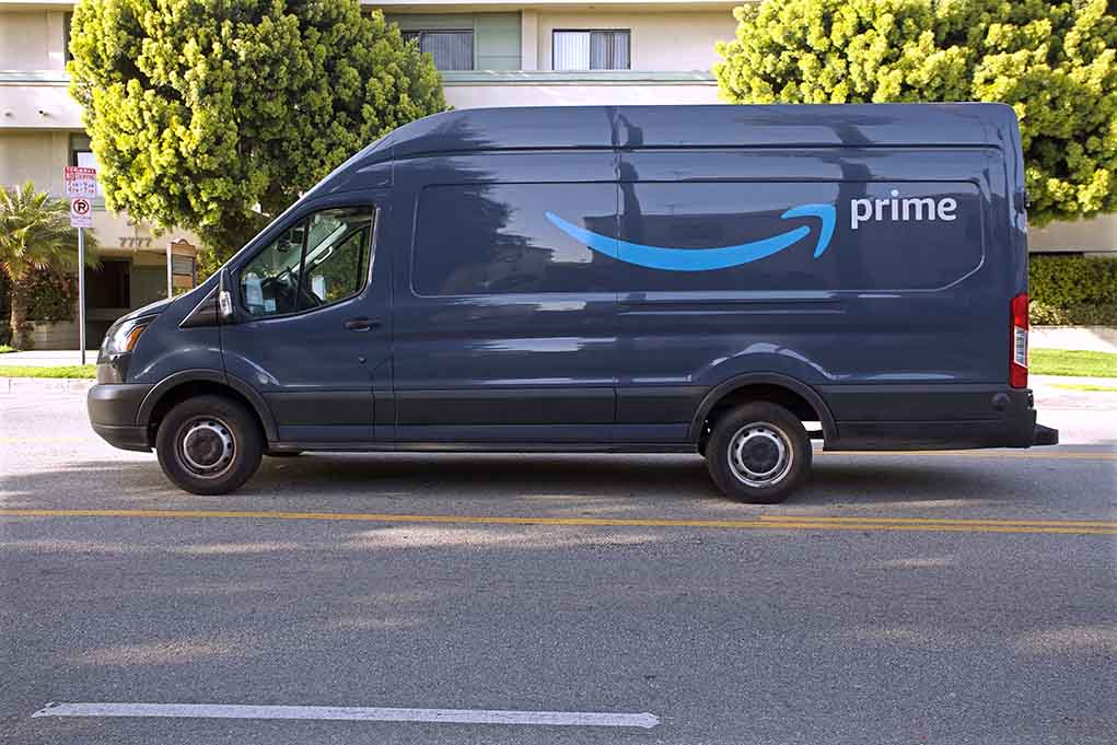 1942217554 featured image Prime delivery van parked on the street.