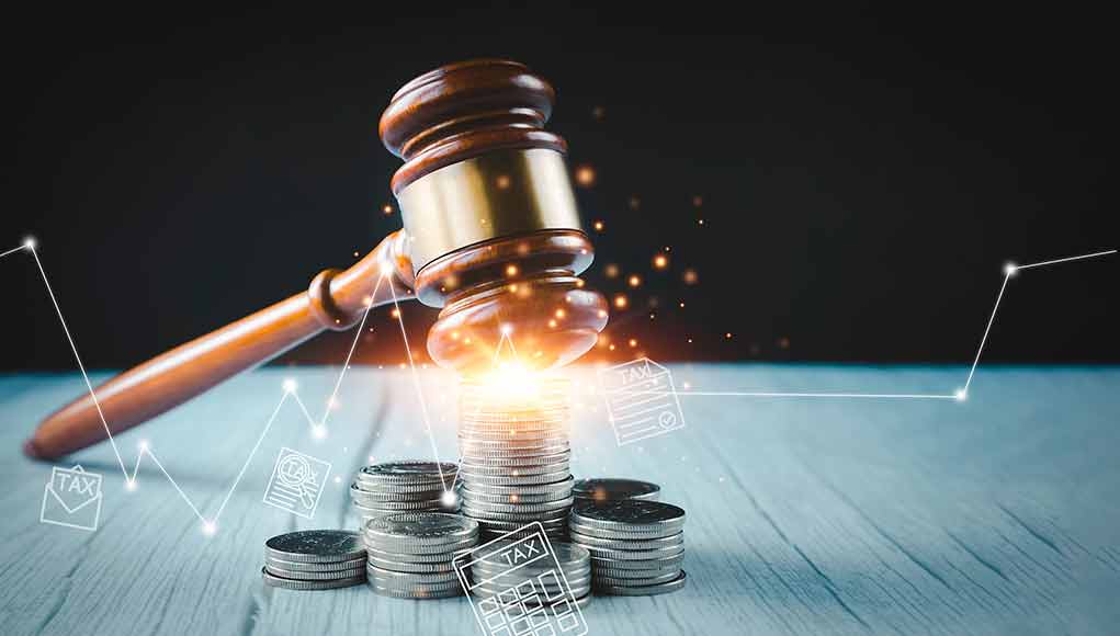 2094447643 featured image Gavel, coins, and tax icons on a table.