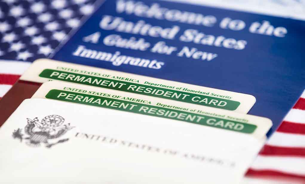 232231384 featured image Permanent resident cards with welcome guide and flag.