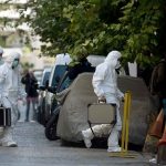 Judge Rules On Crucial DNA Evidence In Notorious Idaho Case Investigators in hazmat suits carrying equipment cases.