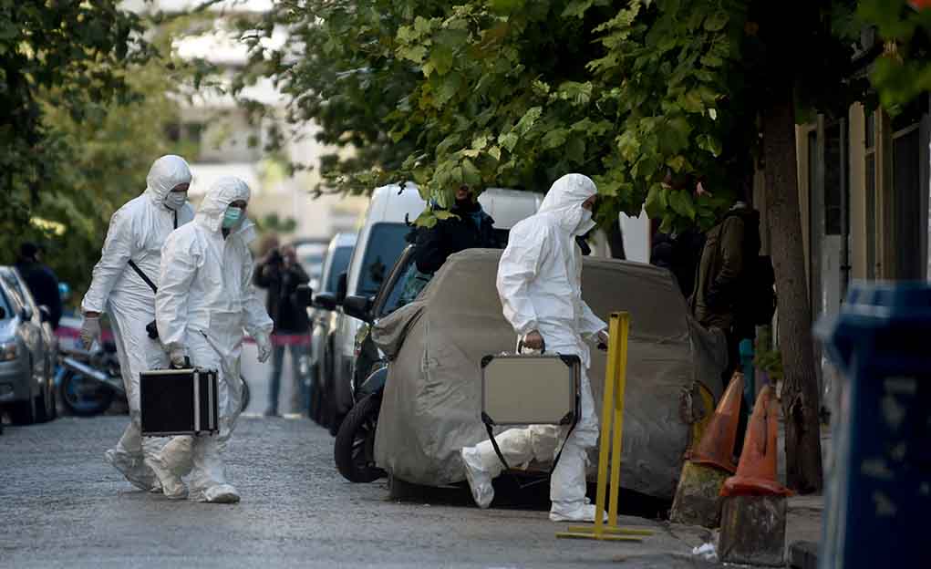 779710051 featured image Investigators in hazmat suits carrying equipment cases.