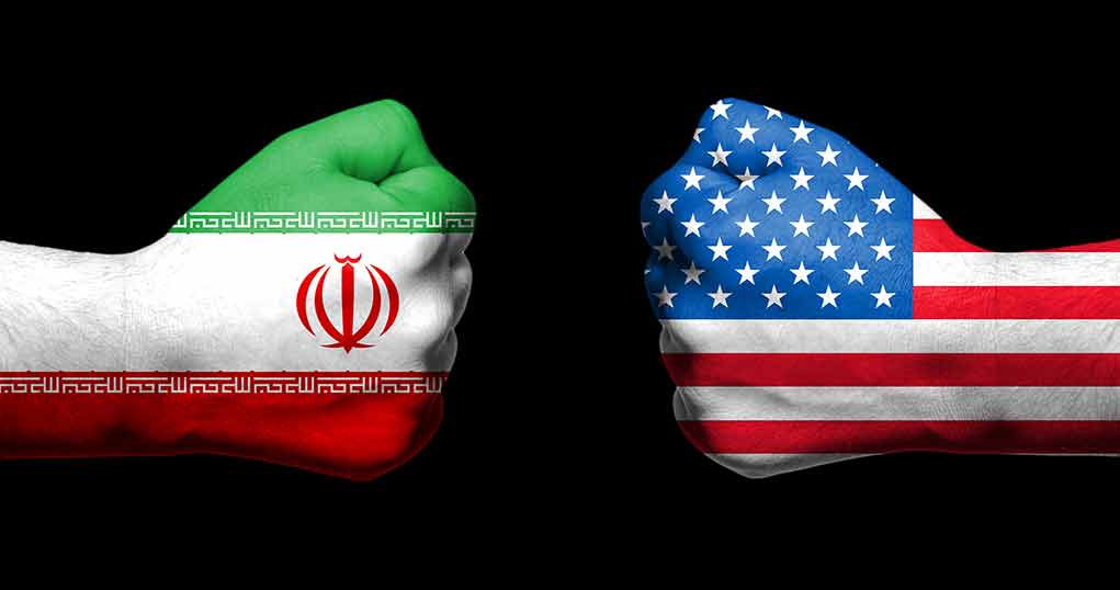 Fists with Iranian and American flags facing off