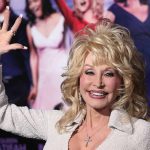 Dolly Parton’s Heartfelt Tribute To Late Husband Carl Dean Woman smiling and waving on red carpet event