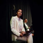 Ocasio-Cortez Sparks Tensions Over Schumer’s Controversial Funding Decision Representative Alexandria Ocasio Cortez in a white suit