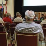 How Leftist Groups Are Influencing GOP Town Halls People attending a meeting in a conference room.