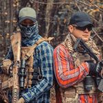 Hidden Horrors: Inside Mexico’s Shadowy Cartel Training Grounds Two armed individuals in tactical gear in forest.