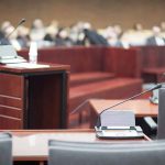 Los Angeles DA Rejecting New Evidence In Menendez Case Empty courtroom with microphones and a podium