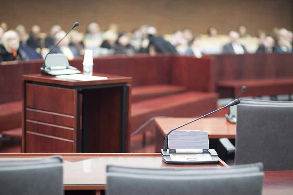 184839455 featured image Empty courtroom with microphones and a podium