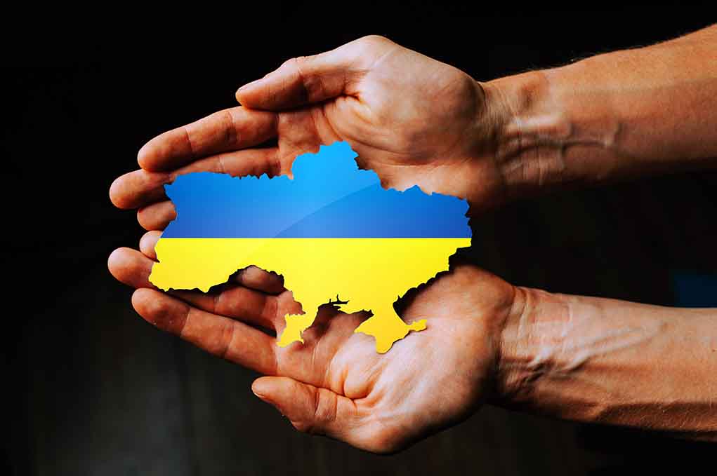 2129047880 featured image Hands holding Ukraine map with flag design.