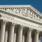 How A 1798 Law Is Influencing Trump’s Modern Migration Policy US Supreme Court building with American flag