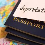 Tighter Borders Are Influencing Smuggling And Self-Deportation Patterns Passports stacked with deportation note on top.