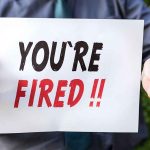 Cartoonist Ousted By University Amid Controversial Turmoil Person holding YOU'RE FIRED sign.