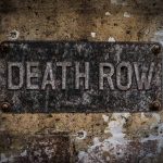 Inmate’s Controversial Execution Choice: Firing Squad Weathered Death Row sign on aged concrete wall