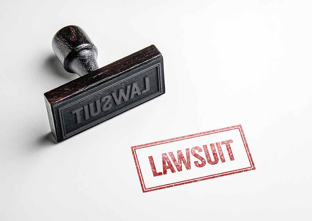 Rubber stamp with lawsuit text on paper