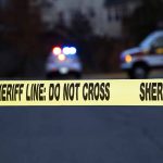 Family Tensions And Tragedy Spark Violence at FSU Sheriff line tape with emergency vehicles in background.