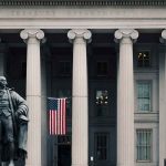 Mass IRS Resignations Threaten To Reshape Nationwide Taxation US Treasury Department building with statue and flag.