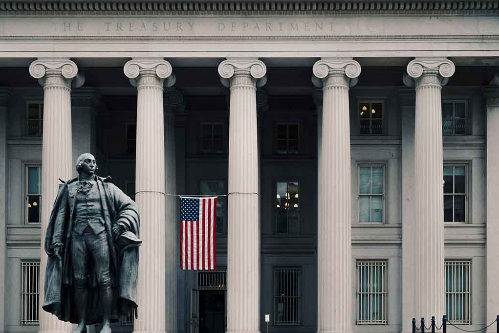 1240657660 featured image US Treasury Department building with statue and flag.