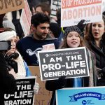 Controversy In Poland Sparks Debate On Reproductive Rights Prolife rally with people holding signs and banners