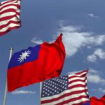 Taiwan Seeks To Ease Trade Tensions In Talks With The US American and Taiwanese flags waving in the sky.