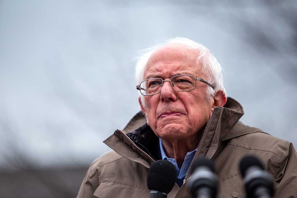 1697942074 featured image Elderly man in jacket speaking at outdoor event.
