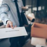 FAA Chief Executive Resigns Amidst Safety Probe Of Recent Tragedies Person handing over a resignation letter.