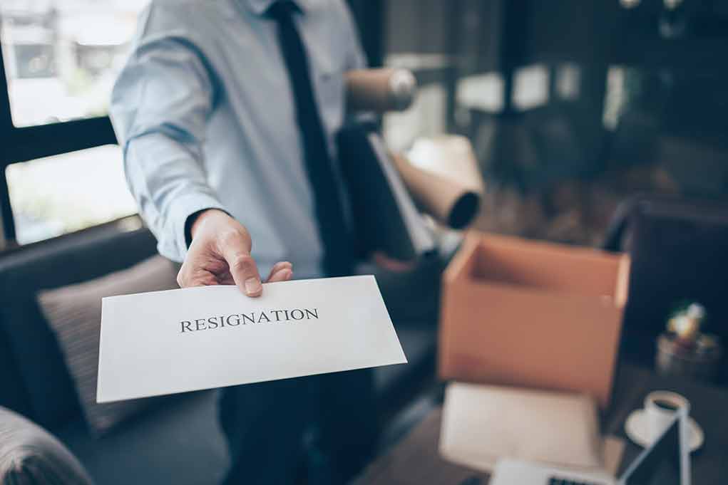 2022335198 featured image Person handing over a resignation letter.